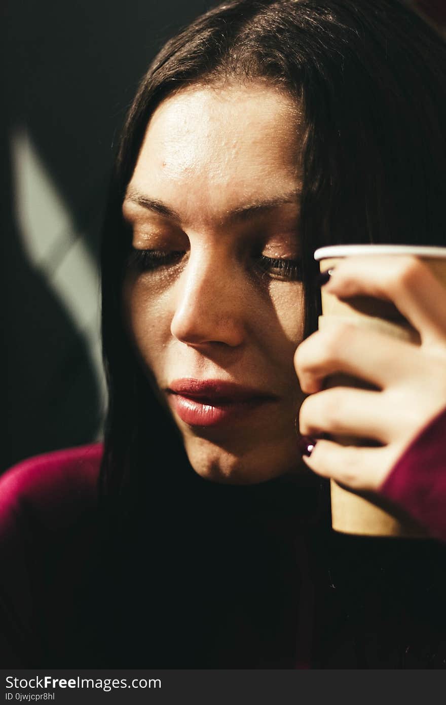 Woman Holding Brown Cup