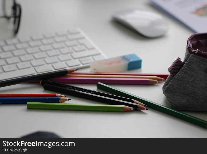 Shallow Focus Photography of Assorted Pencils Near Apple Keyboard and Mouse