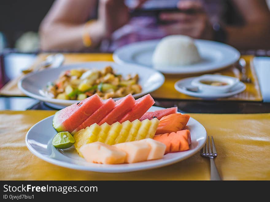 Round Ceramic Plate Filled With Sliced Watermelon, Pineapple, and Carrots