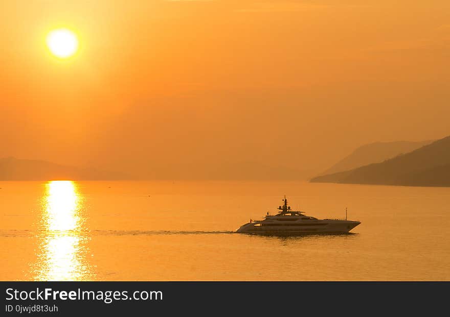 Sailing Cruise Ship during Yellow Sunset