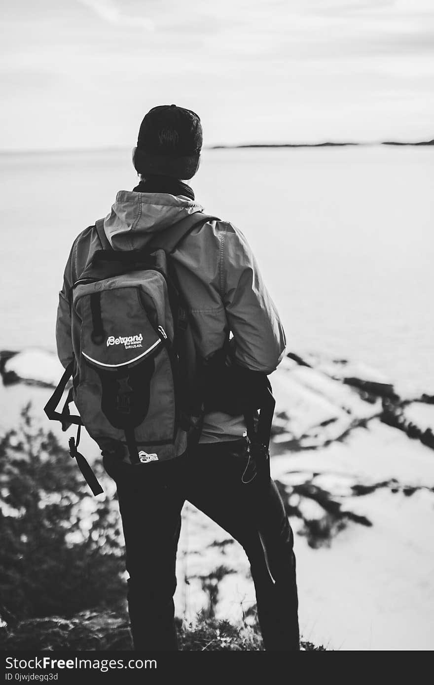 Grayscale Photo of Man Wearing Windsor and Backpack