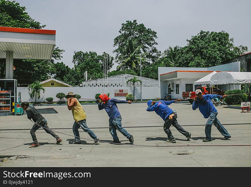 Five Men Pulling Black Rope