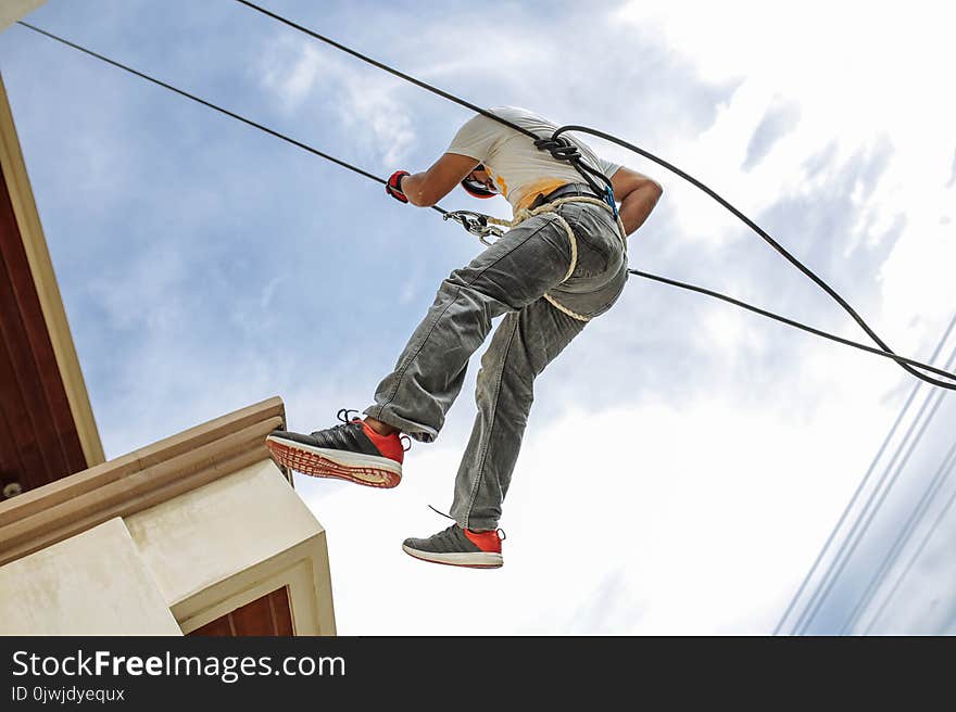 Man Wearing Harness Going Down Building