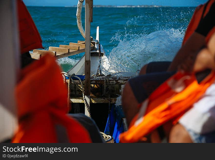 Person Riding a Boat Wearing Life Vest