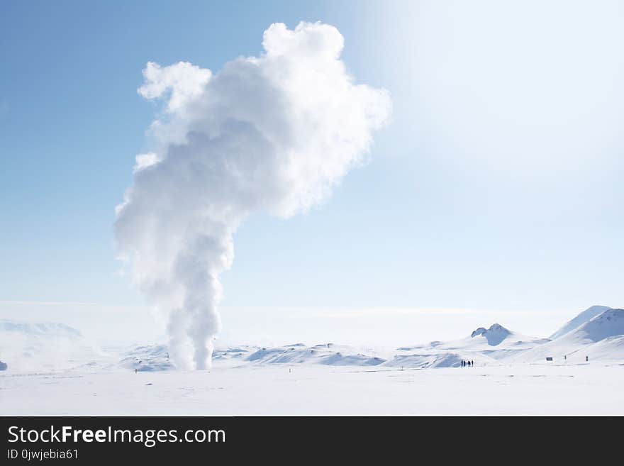 Smoke Rising from Snow-covered Field