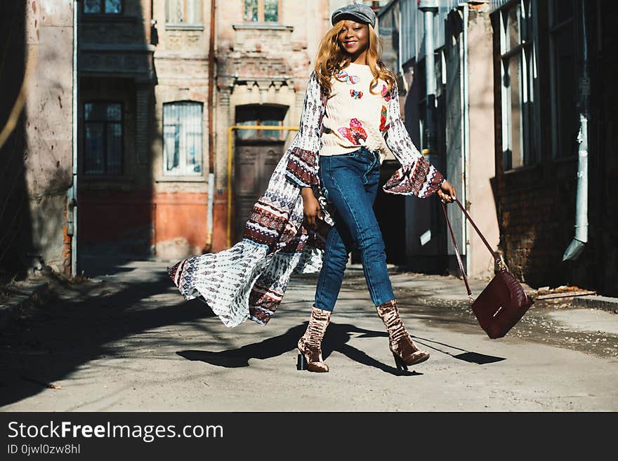 Woman Holding Bag Near Buildings