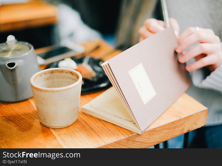 Woman Holding Brown Open Notebook