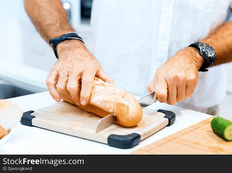 Male Hands Cutting Bread