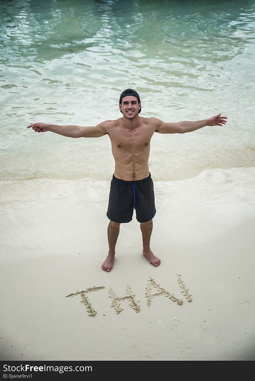 Cheerful man on sand beach