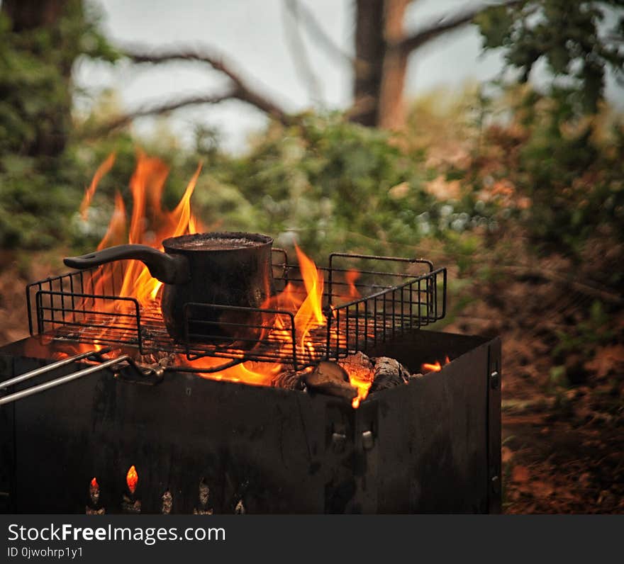 Close-up of black turkish coffee cooking on the fire