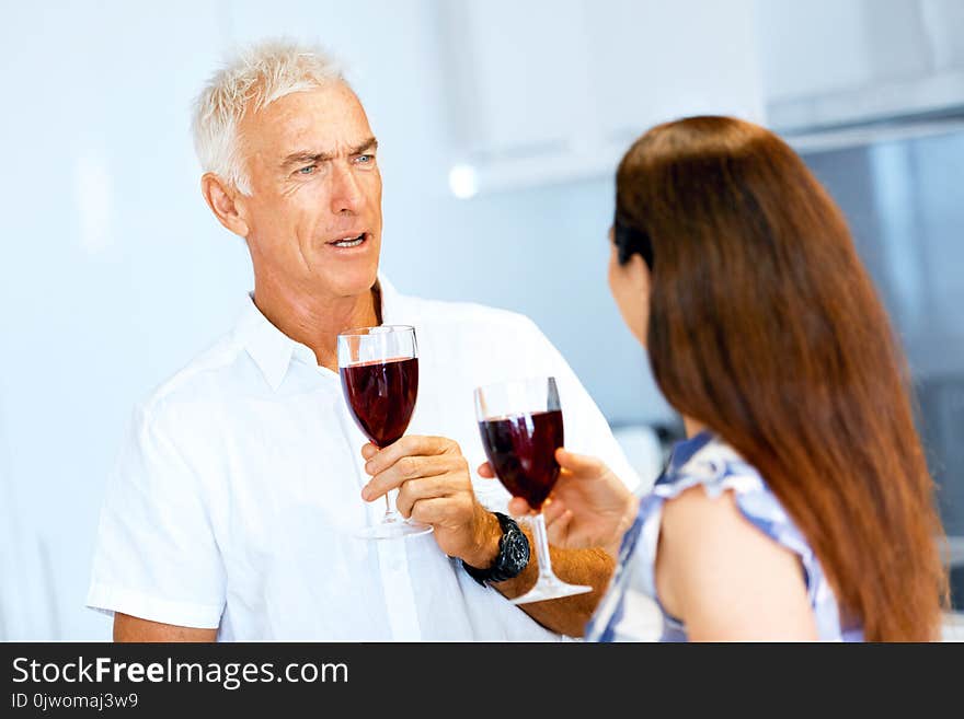 Portrait Of A Couple Having A Glass Of Red Wine