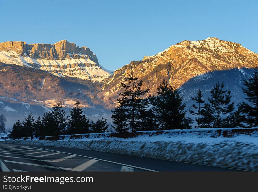 Low sun illuminatating the mountains near the town of Chamonix-de-Mont Blanc on an early winter`s afternoon. Low sun illuminatating the mountains near the town of Chamonix-de-Mont Blanc on an early winter`s afternoon.