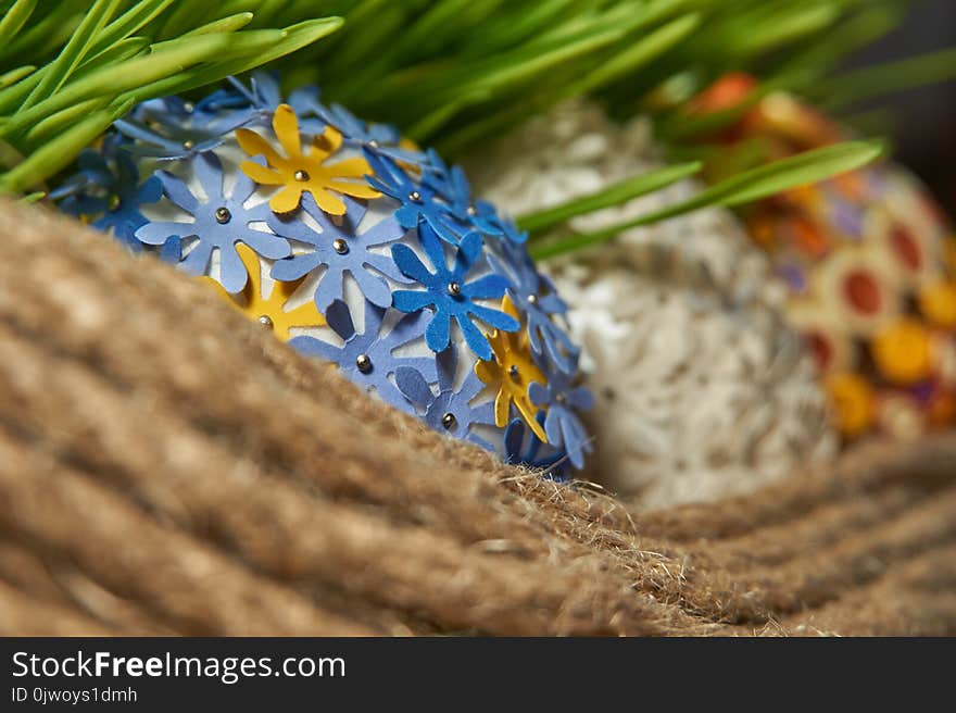 The Easter egg decorated with multicolored paper, placed between frech green wheat germs and jute rope. Easter Craft Ideas. The Easter egg decorated with multicolored paper, placed between frech green wheat germs and jute rope. Easter Craft Ideas.