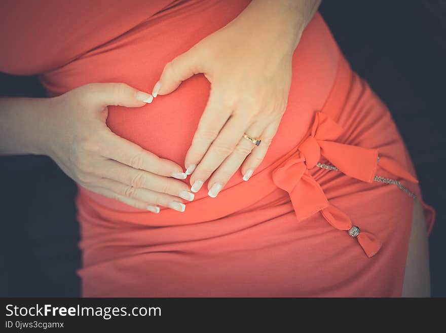 Elegant pregnant woman heart shape hands on belly. Elegant pregnant woman heart shape hands on belly