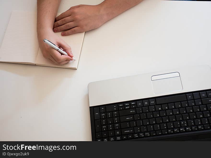 Right hand writing on notebook