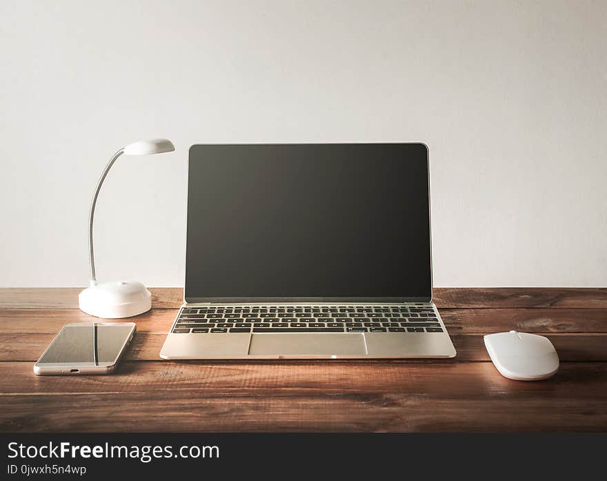 Blank screen Laptop, mobile phone, mouse, on work table