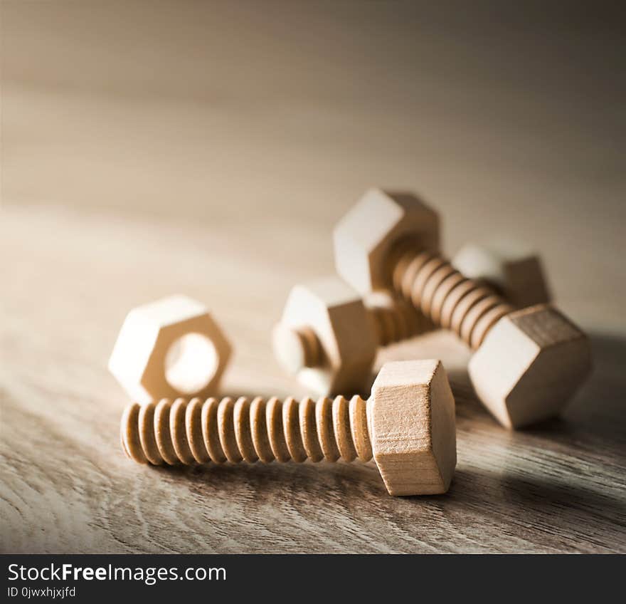 Wood nut and bolt on wood table work concept.