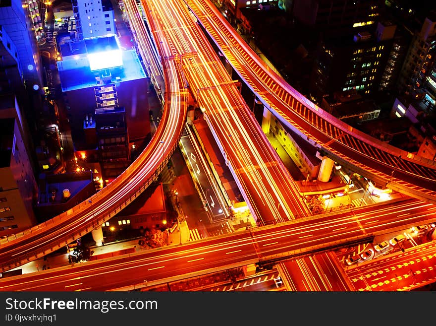 The highway in the big city, expressway enter the city, night light picture by drone on top view. The highway in the big city, expressway enter the city, night light picture by drone on top view.