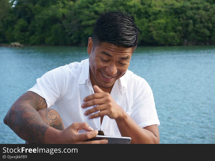 Man on seawall on vacation in Japan with white shirt 6