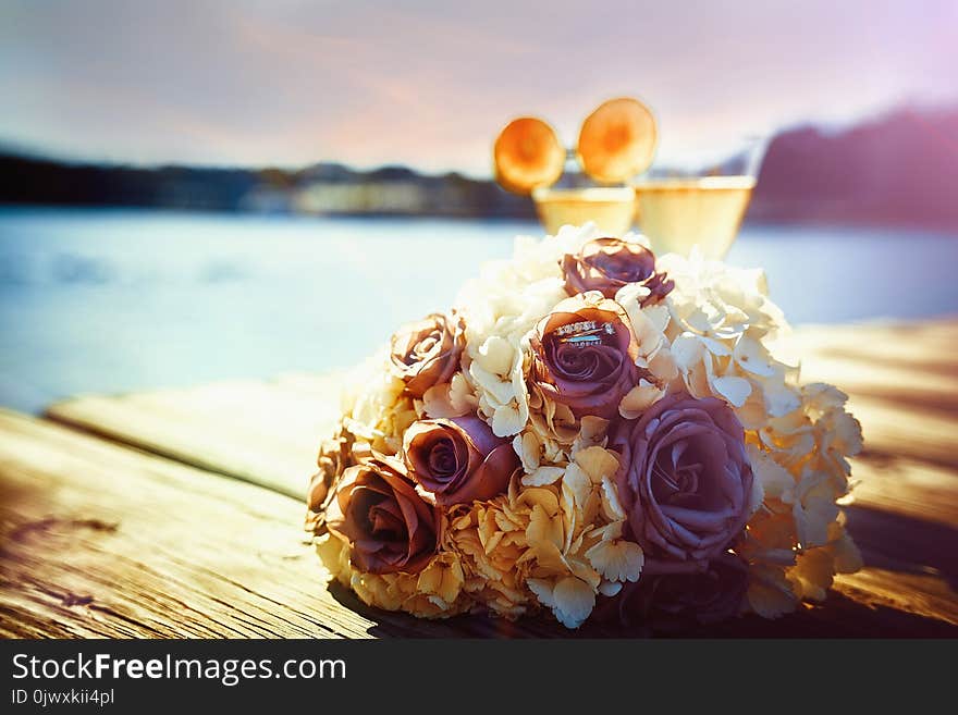 Wedding golden rings in glass of champagne. Symbol of love and marriage.