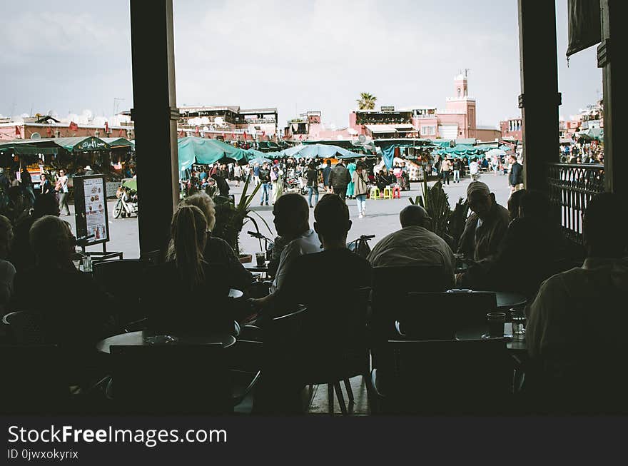 Silhouette Photo of People Sitting on Chairs