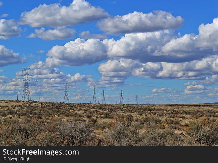 Black Electric Posts Under White Clouds