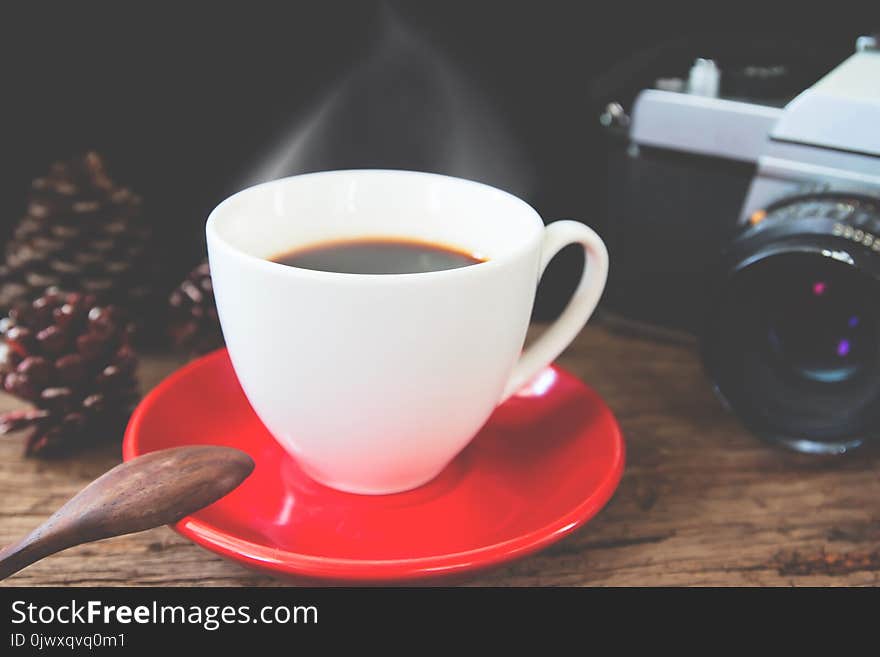 Cup Of Hot Coffee With Film Camera On Wooden Table, Vintage Filter Effect