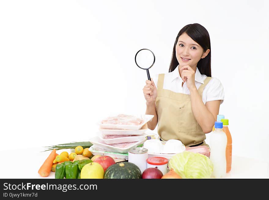 Asian housewife with a magnifying glass