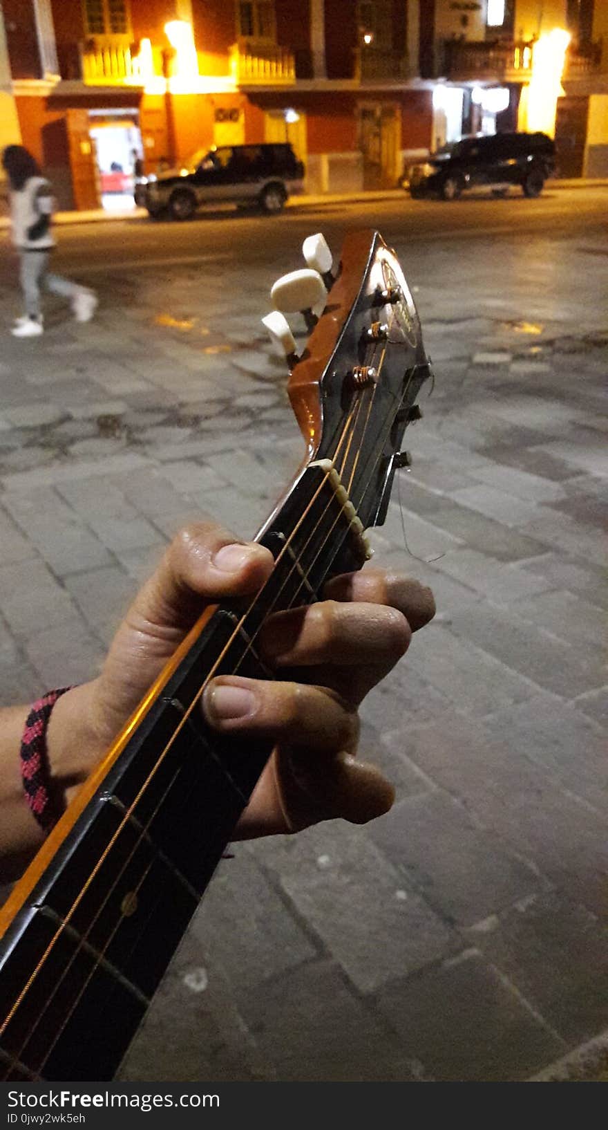 Hand playing a guitar