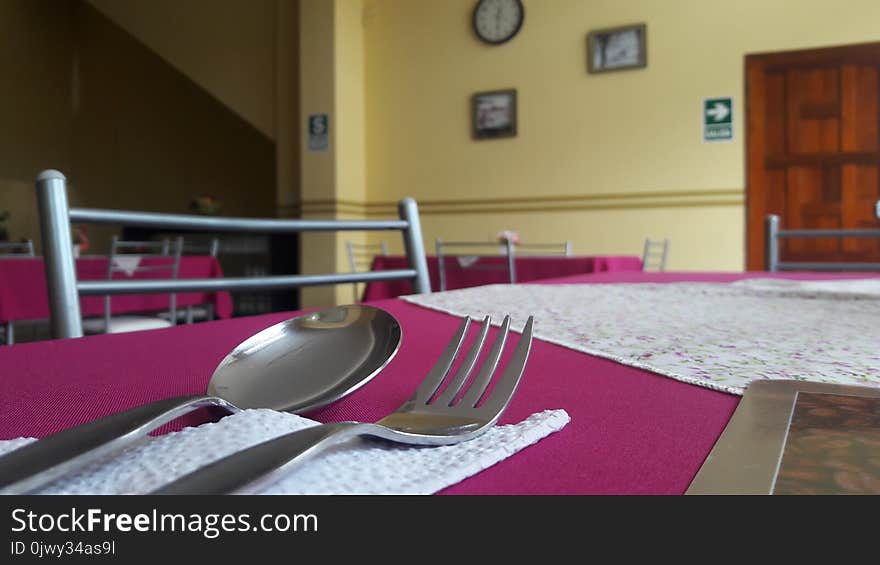 A Spoon And A Fork Over A Dining Table