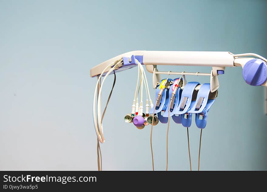 Accessories of electrocardiogram and the wall background, medical instrument used to monitor heart rate in heart disease patient.