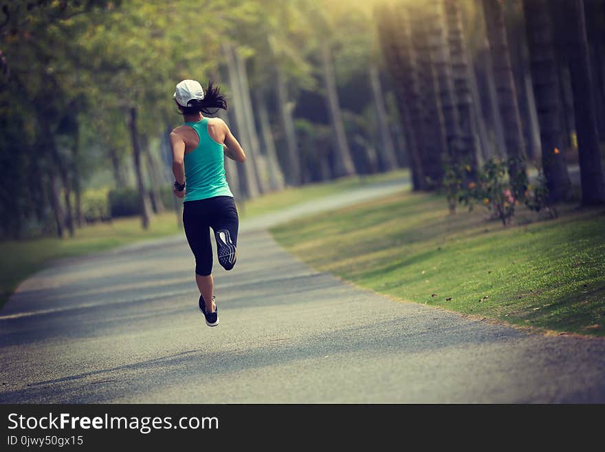 Sporty fitness woman running at park. Sporty fitness woman running at park