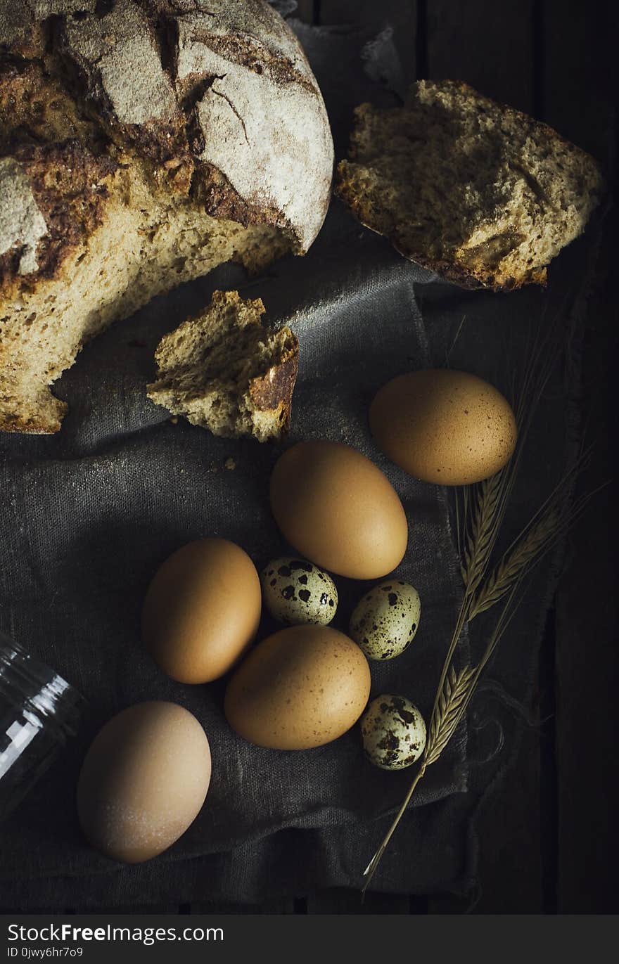 Loaf of rye bread with chicken eggs in wooden box