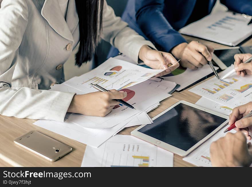 Image of business partners meeting to discuss the situation on the market discussing documents and ideas at meeting