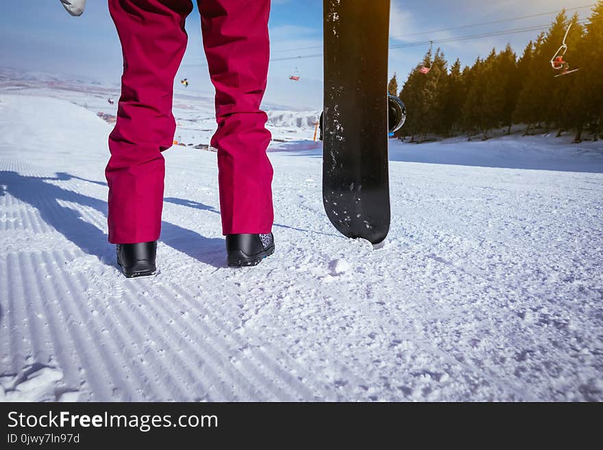 Snowboarder With Snowboard On Ski Slope