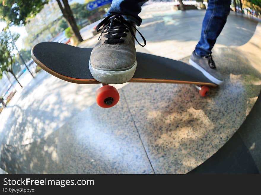 Skateboarder legs riding skateboard
