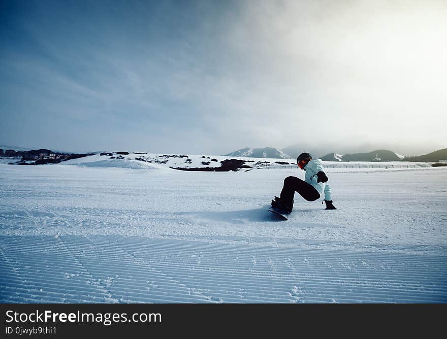 Snowboarder snowboarding in winter mountains