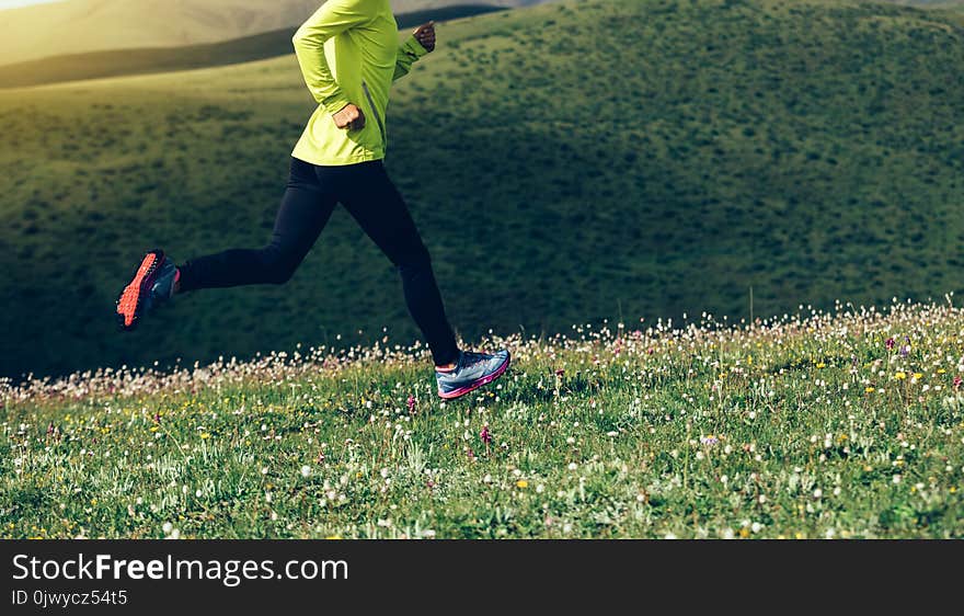 Fitness Woman Runner Running On Mountain Grassland