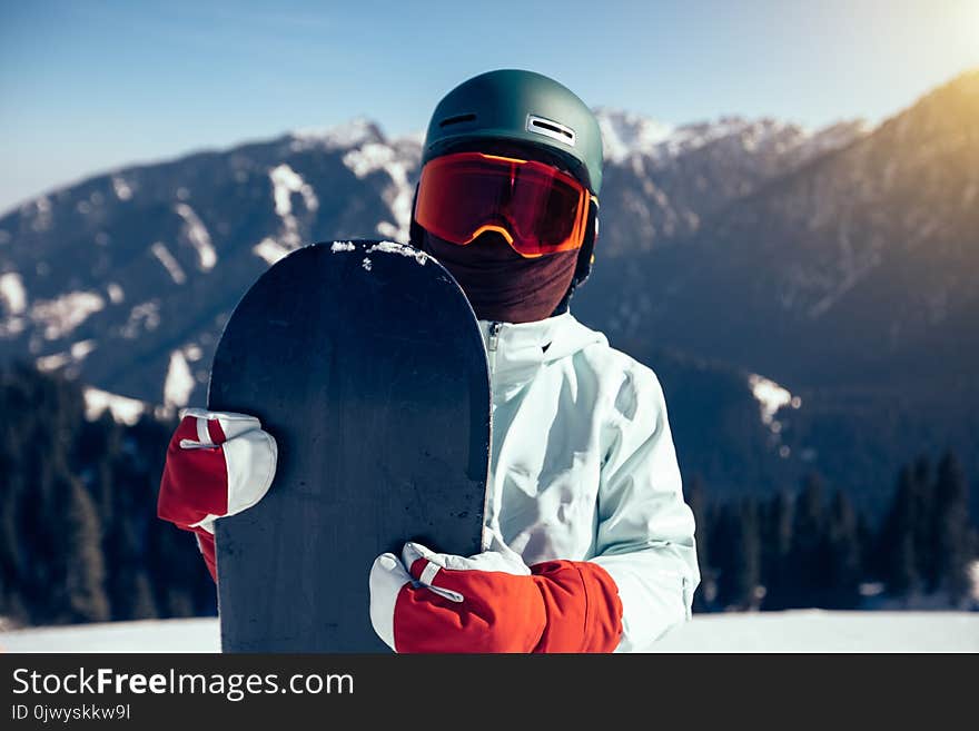 Snowboarder With Snowboard On Winter Mountain Top