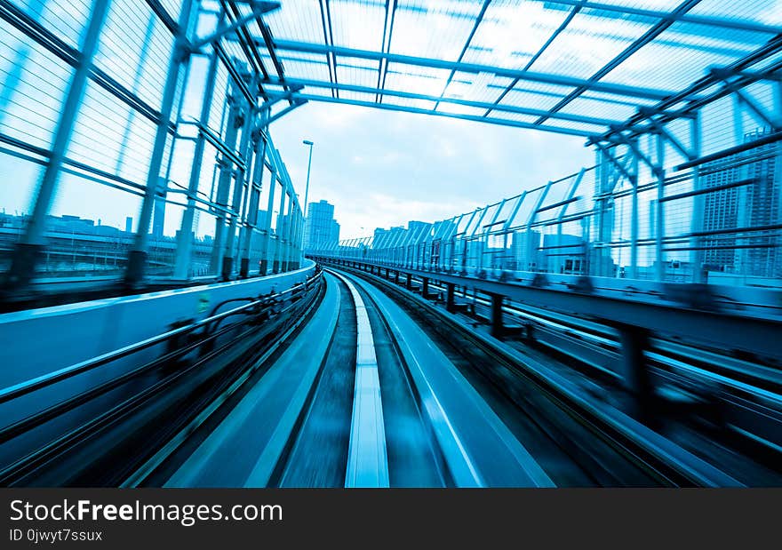 Front view of train moving in city rail tunnel with moderate motion blur and blue tone filter. Transportation concept and motion blur background abstract. Front view of train moving in city rail tunnel with moderate motion blur and blue tone filter. Transportation concept and motion blur background abstract.