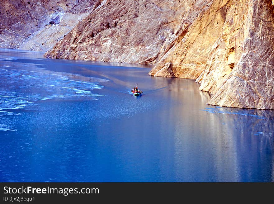 A boat is transporting passengers from the china to pakistan. A boat is transporting passengers from the china to pakistan