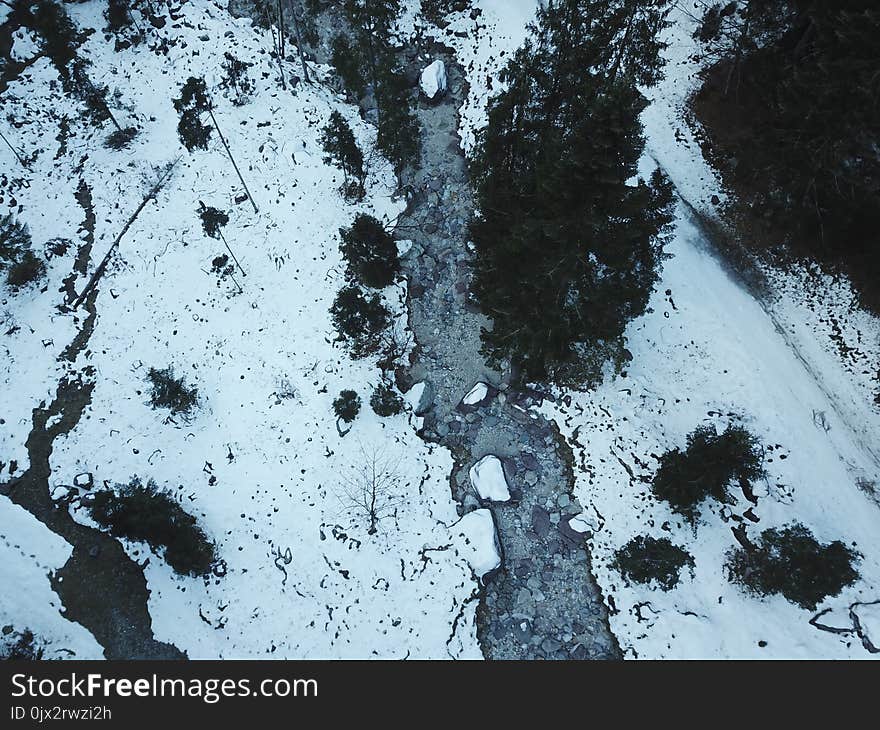 River without water in a frozen valley, aerial view