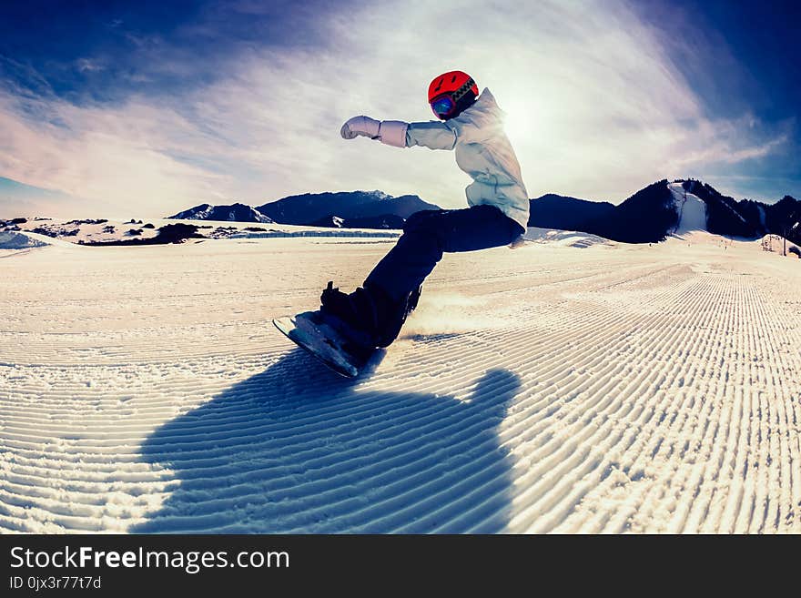 Snowboarding on winter mountain top slope