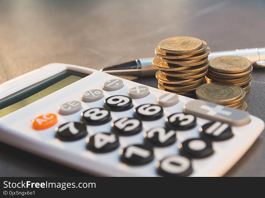 Saving money concept with money coin stack growing and calculator for business and accounting concept.