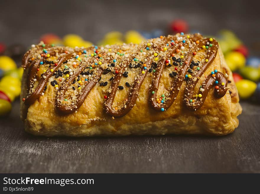 Sugary cake on a wooden dark background. Sugary cake on a wooden dark background.