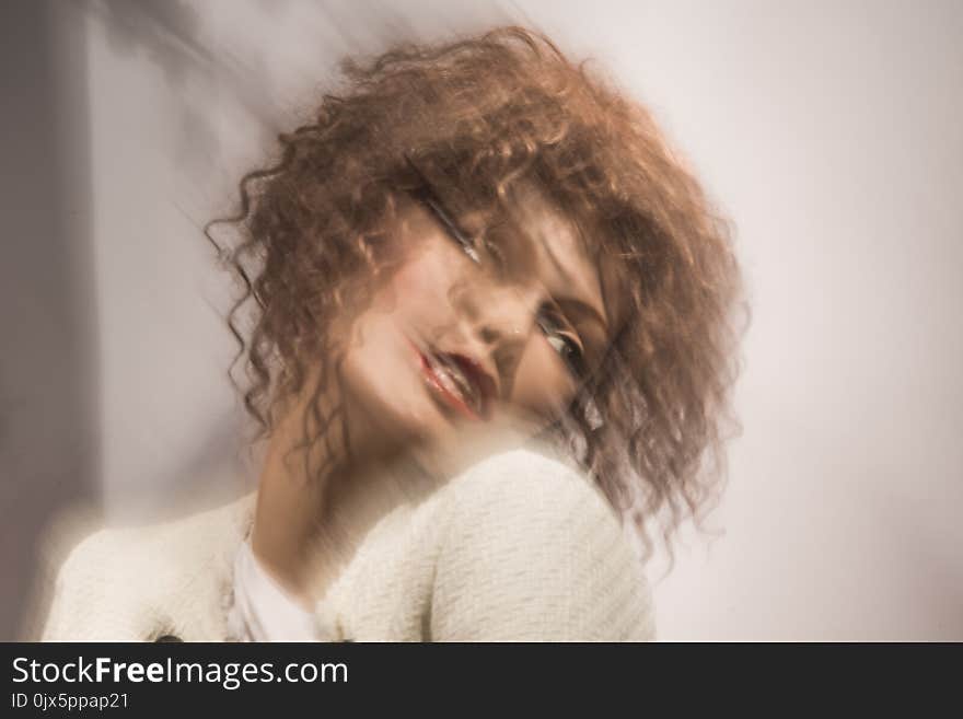 Motion blur and portrait of a woman with dark blond brown curly hair. Motion blur and portrait of a woman with dark blond brown curly hair