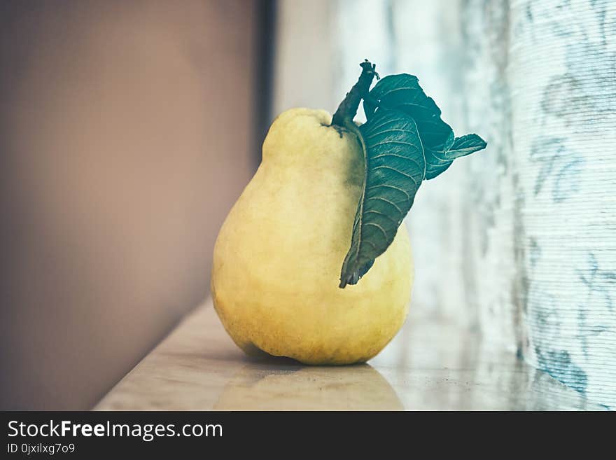 Peach On Table Near Curtain