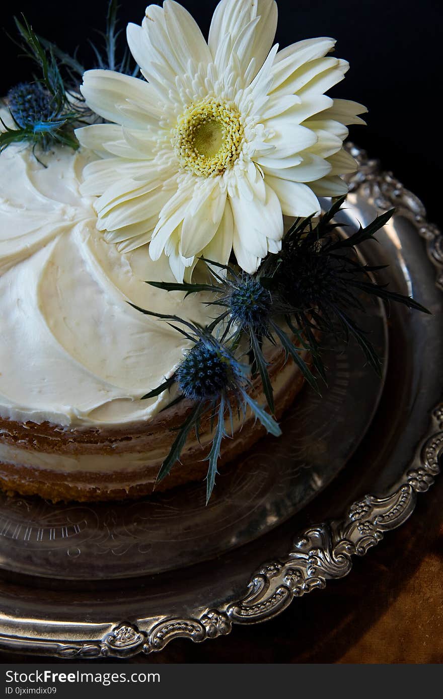 White Flowers on Round Cake With White Cream