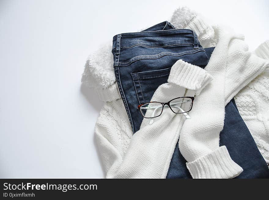 Black Framed Eyeglasses On White Jacket And Blue Denim Bottoms