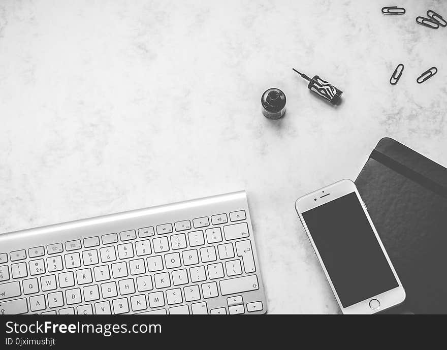 White Android Smartphone and Computer Keyboard